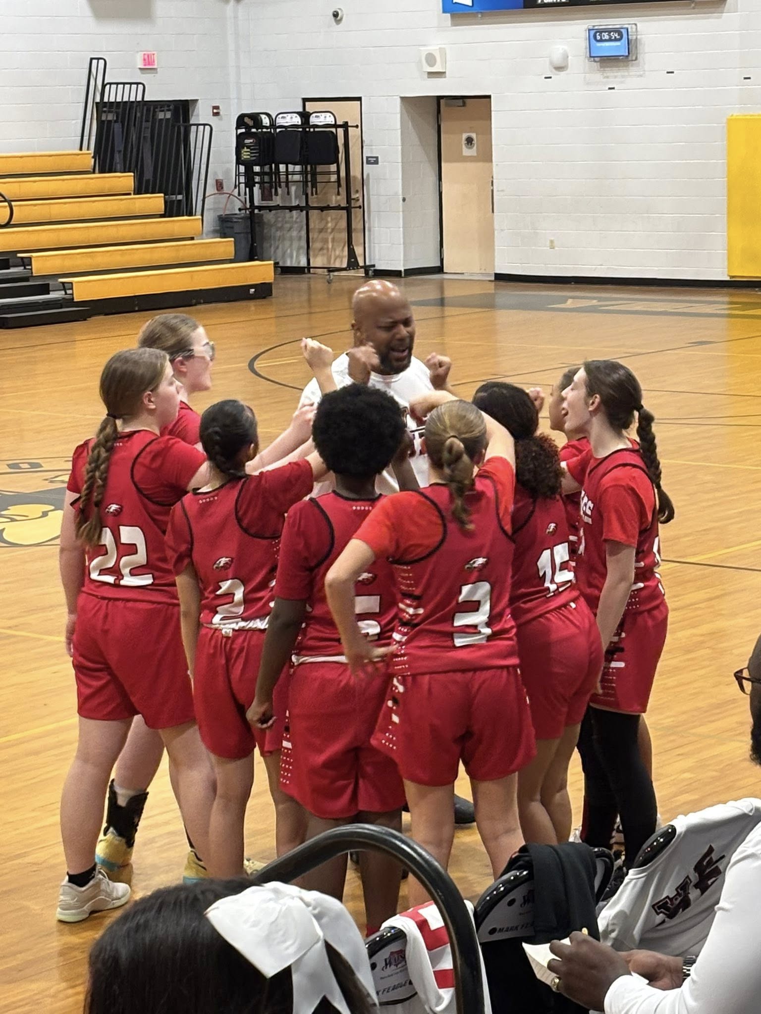 Run & Shoot athletes in a team huddle