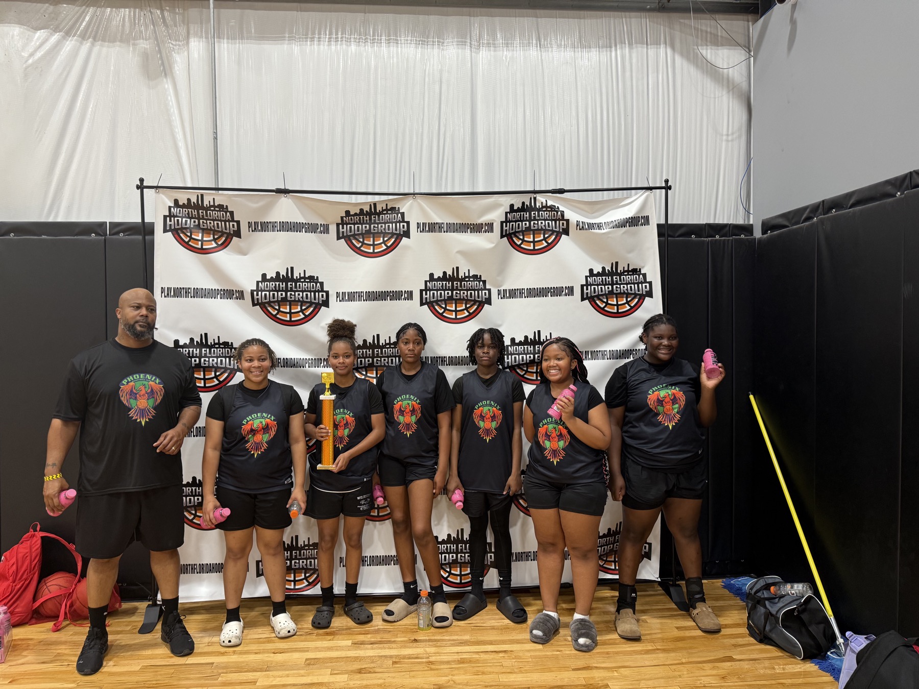 Run & Shoot team celebrating with a trophy